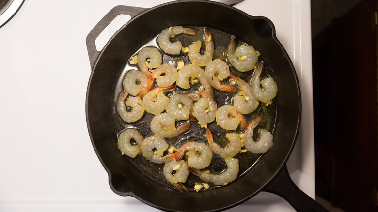 raw shrimp cooking in pan 