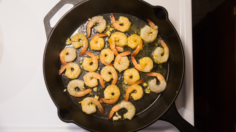 shrimp frying in iron pan 