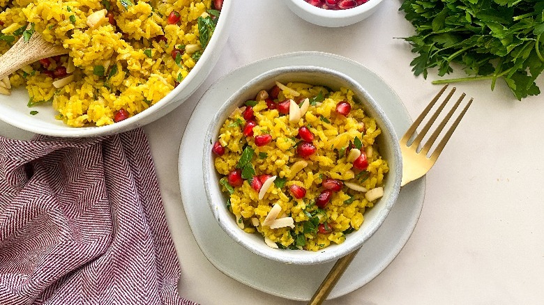 saffron rice in small bowl with large serving bowl