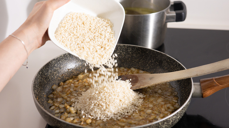 rice going into pan for risotto