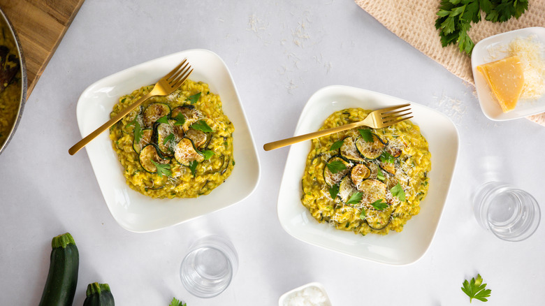 two plates of saffron zucchini risotto