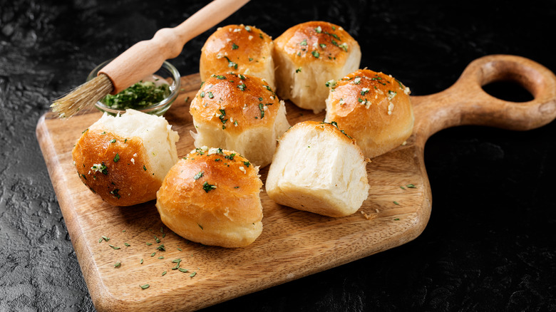 dinner rolls on cutting board