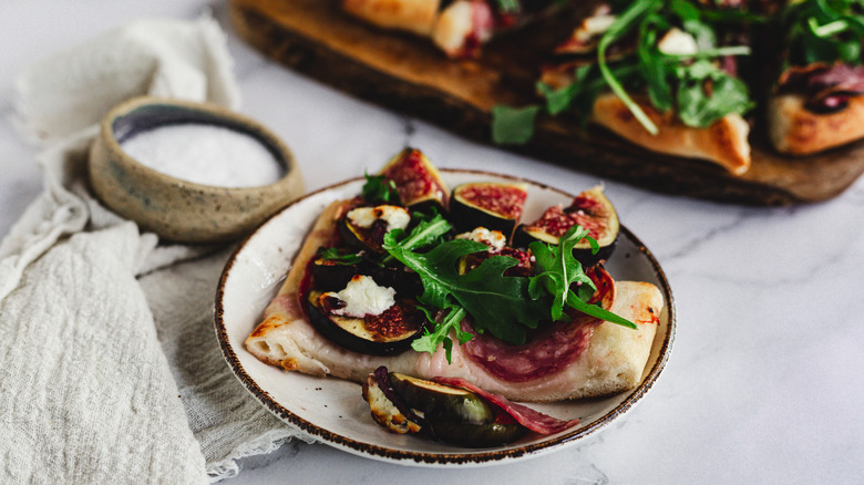 flatbread slice on a plate with flatbread in back