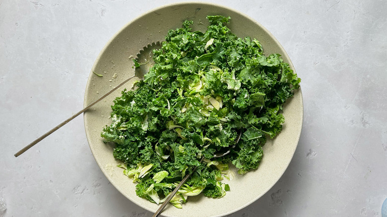 tossing greens in bowl