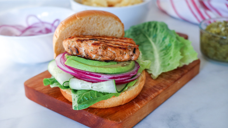 salmon burger on wooden board