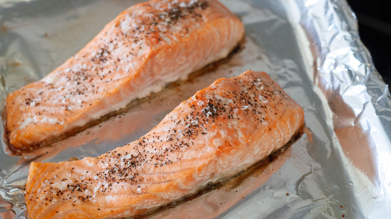 cooked salmon fillets on baking sheet