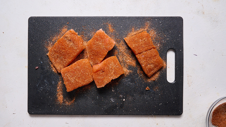 seasoned salmon on cutting board