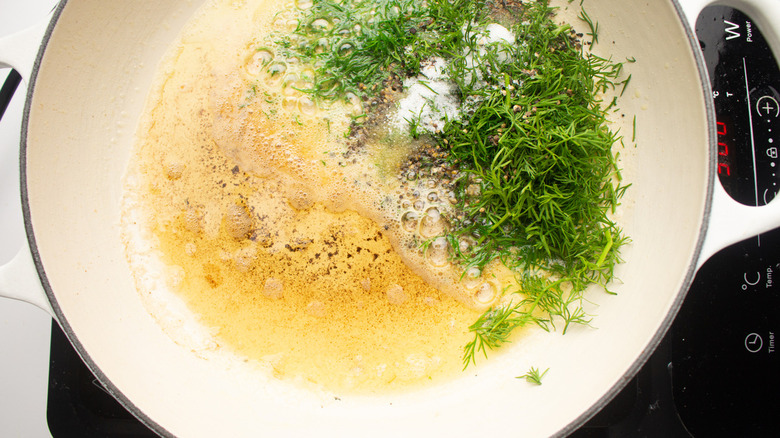 skillet with dill, butter, and seasonings