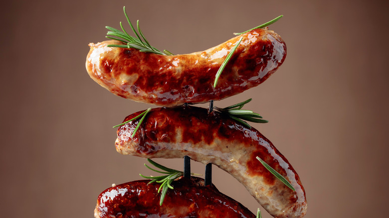 Cooked sausages on grill fork