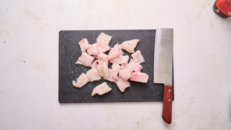 slicing catfish into pieces