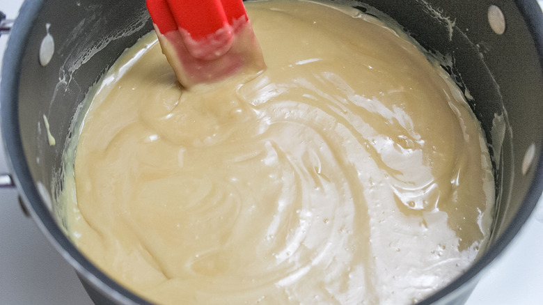 melting rice krispie ingredients in a pan