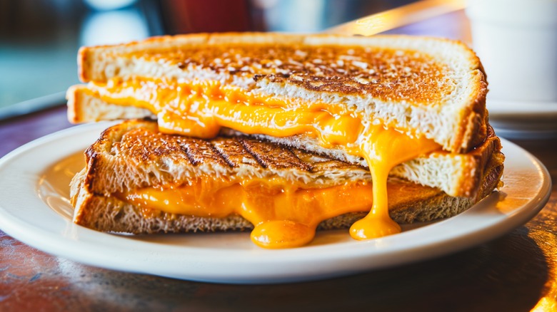 halves of grilled cheese stacked with cheese oozing