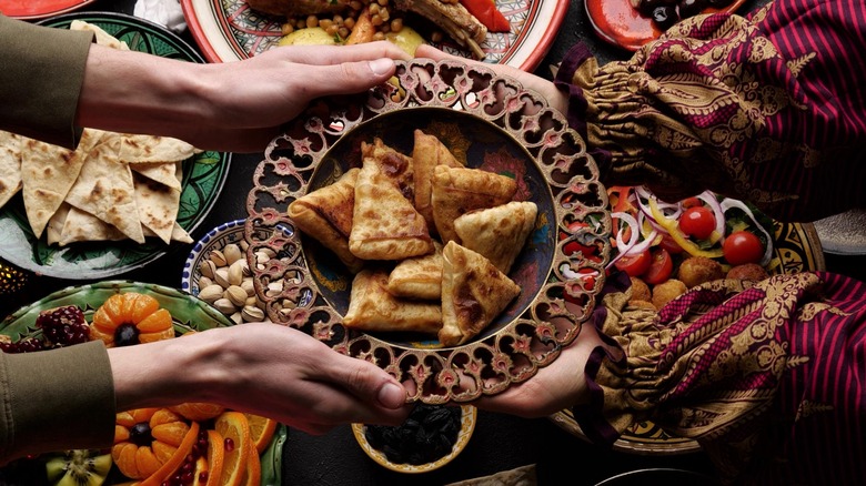 Plate of samosas being passed