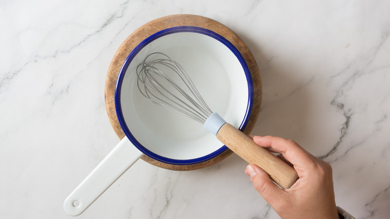 Whisking liquid in saucepan