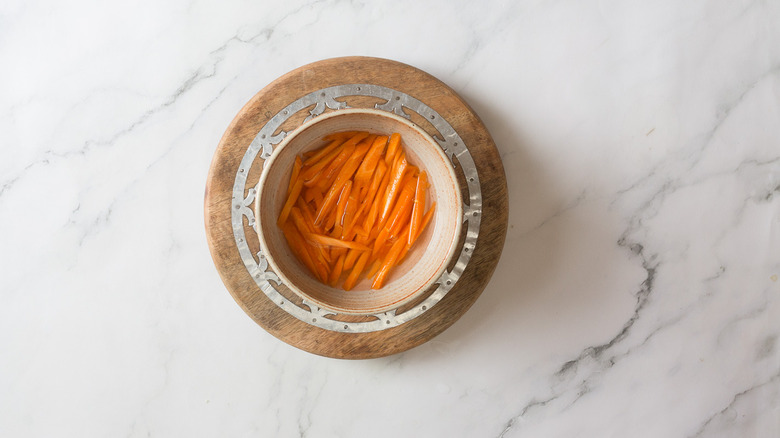 Carrots in bowl with liquid