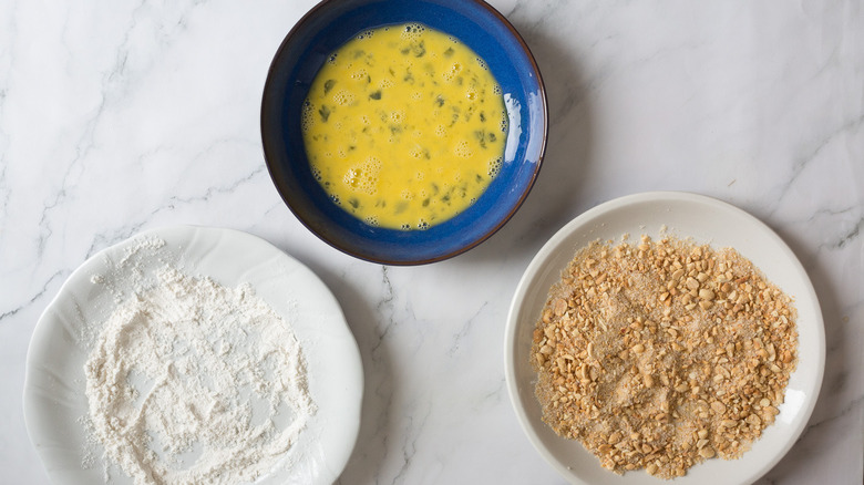 plates with egg, flour, breadcrumbs