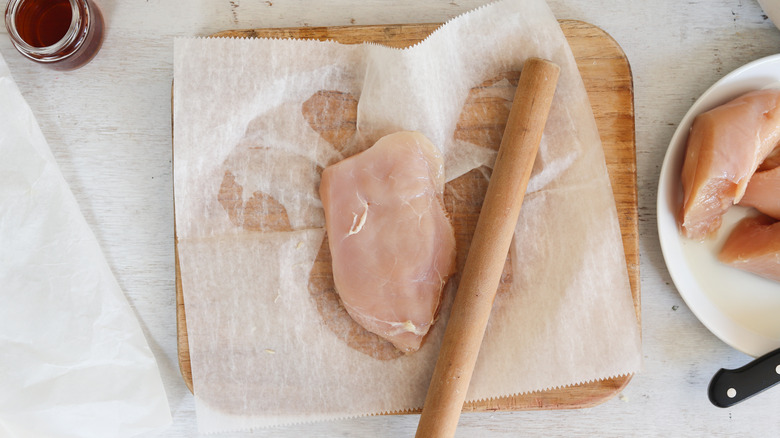 flattened chicken breast on board