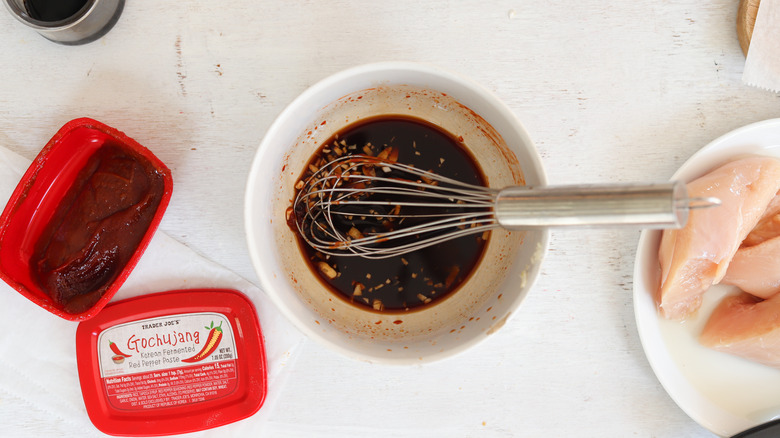 whisking marinade ingredients in bowl