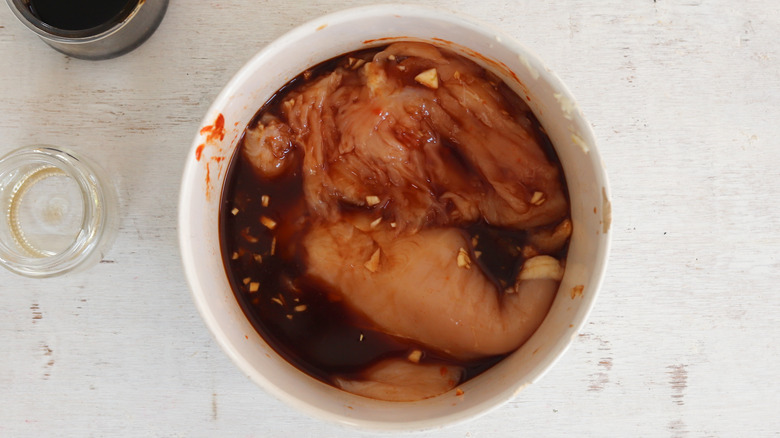 chicken marinating in bowl