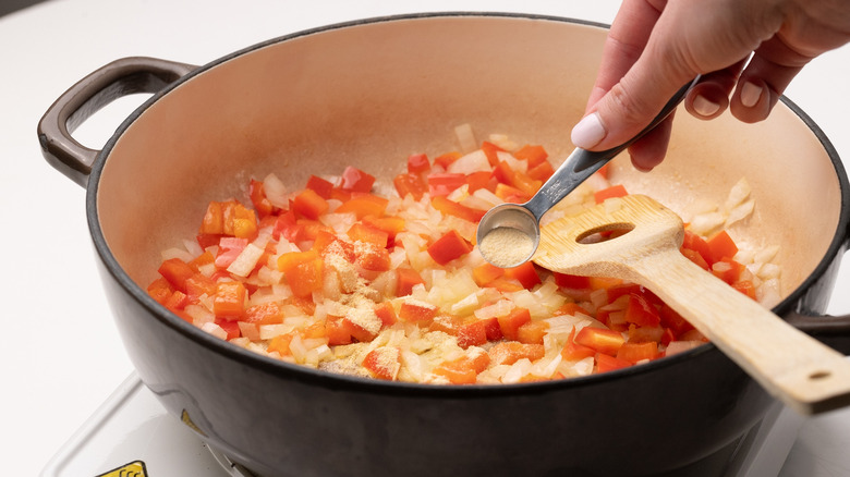 adding garlic powder to pan