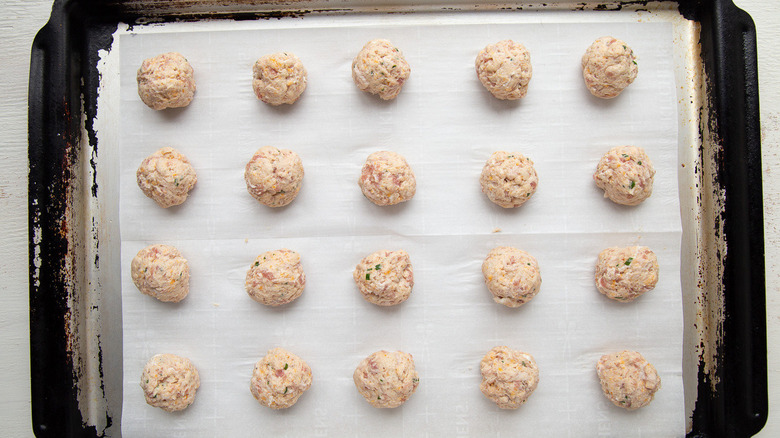 uncooked sausage balls on baking sheet