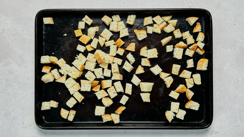 bread cubes on a sheet tray