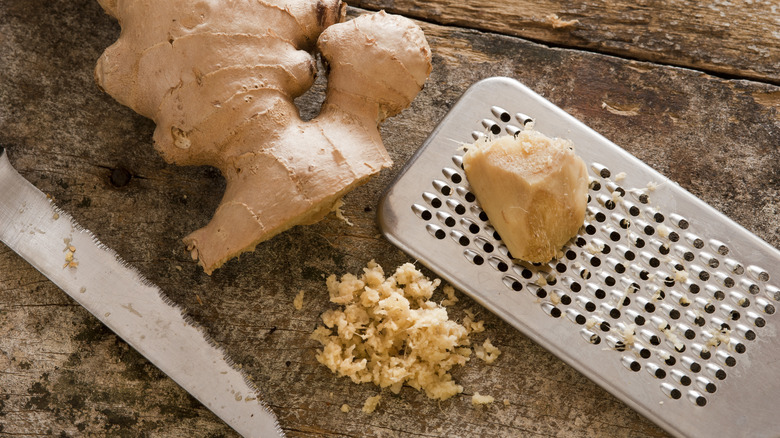 Grated ginger with knife and metal grater