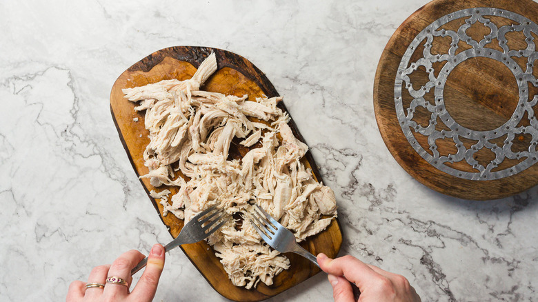 Shredding chicken with two forks