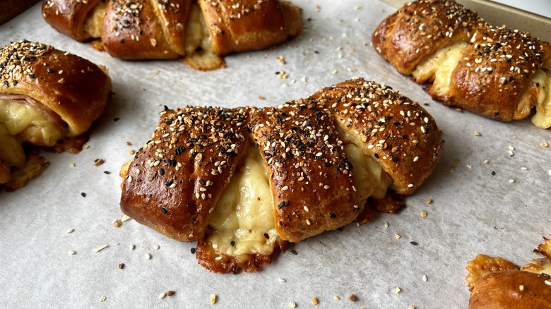 close-up of ham and cheese bear claws on baking sheet