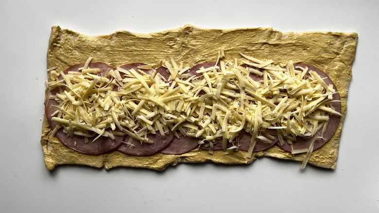 shredded cheese on top of ham