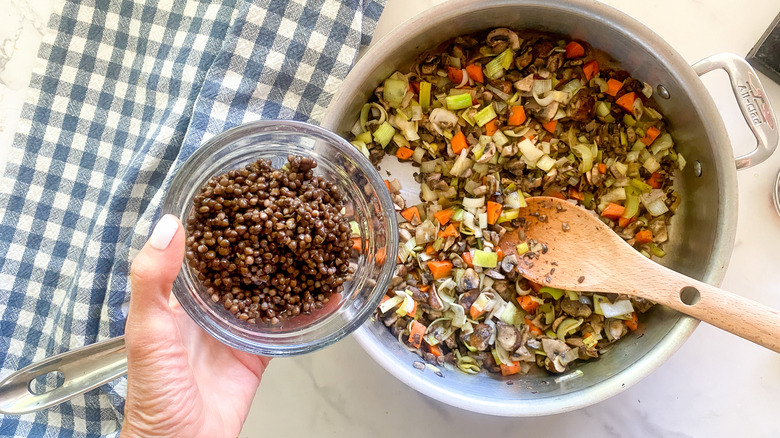 adding lentil to pan