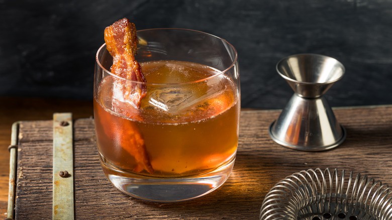 Close-up of an Old Fashioned cocktail with bacon