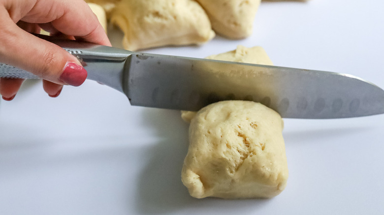 knife cutting through dough