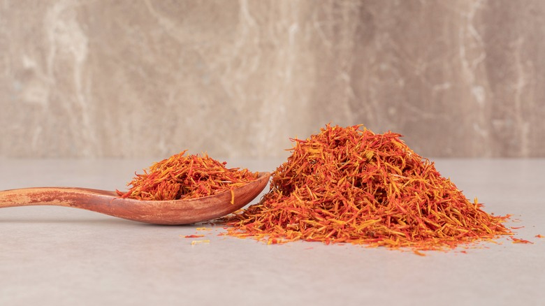 Pile of dried saffron wood spoon