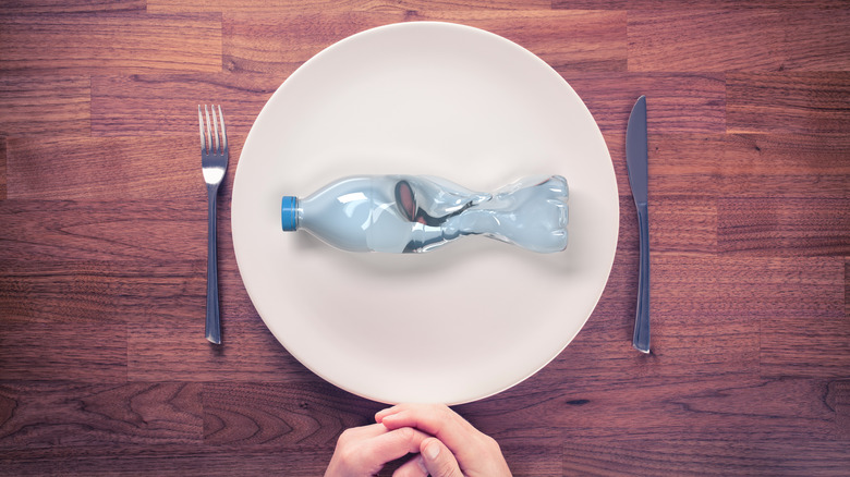 plastic water bottle on plate