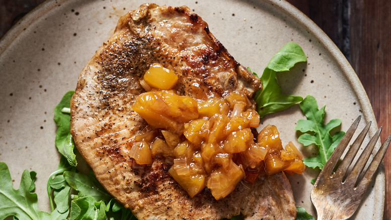 pork chop with chutney on plate