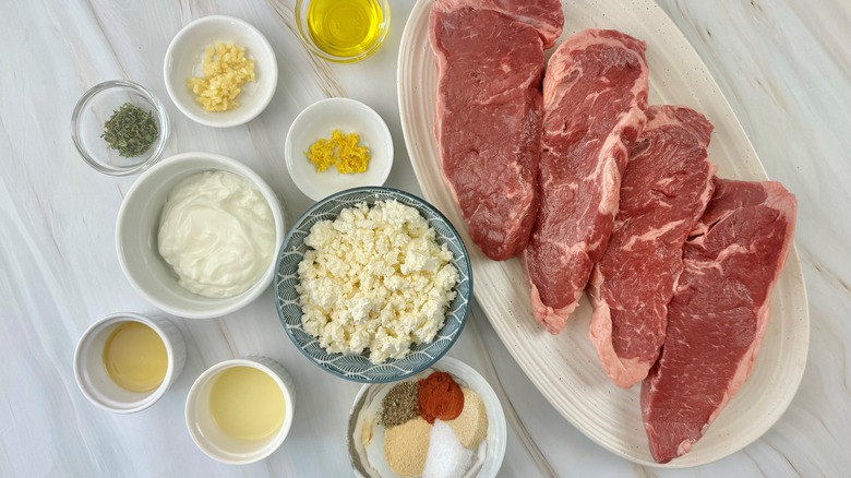 steaks with seasonings and cheese