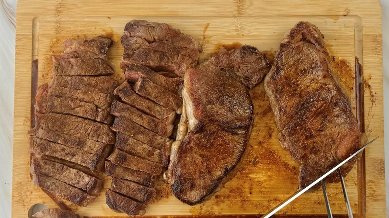 knife cutting steaks into strips