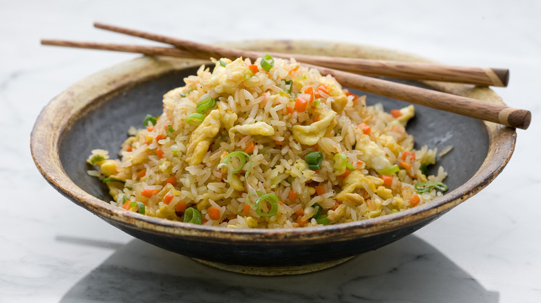 Fried rice in a black wooden bowl