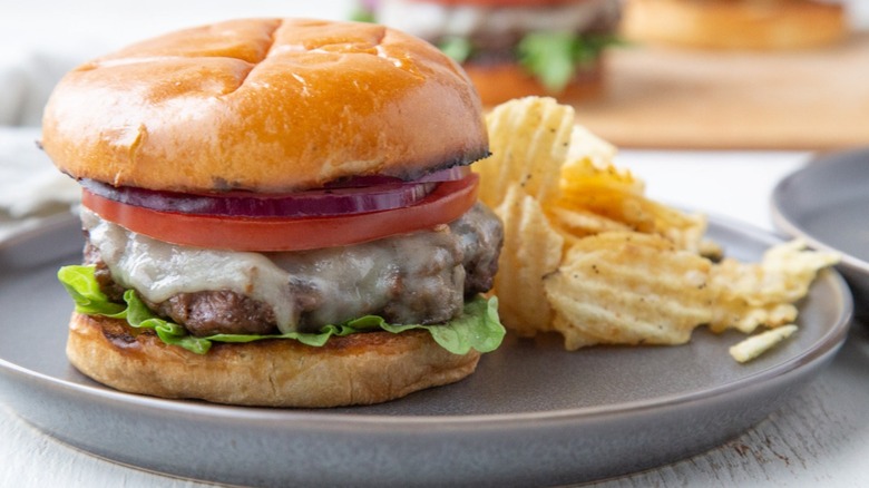 Ranch cheeseburger on plate with chips