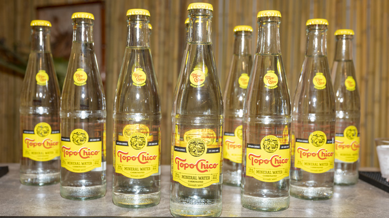 Topo Chico mineral water bottles on bar