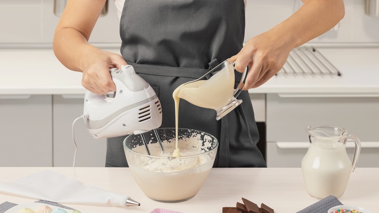 A person whipping ingredients in bowl