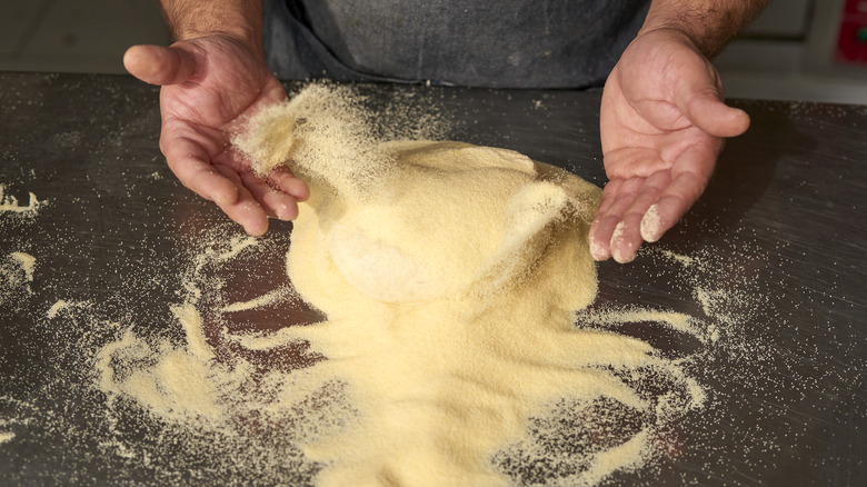 preparing pizza with semolina