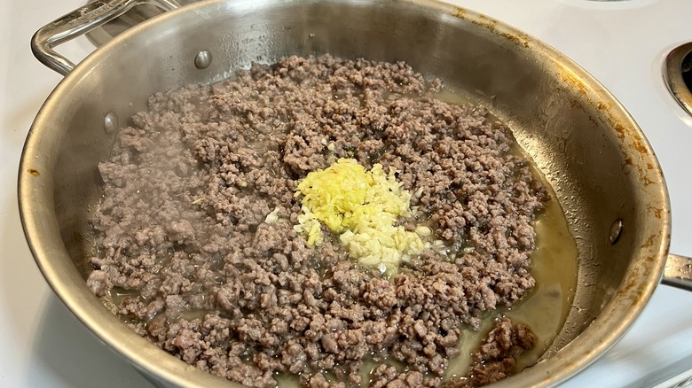 beef and alliums in skillet