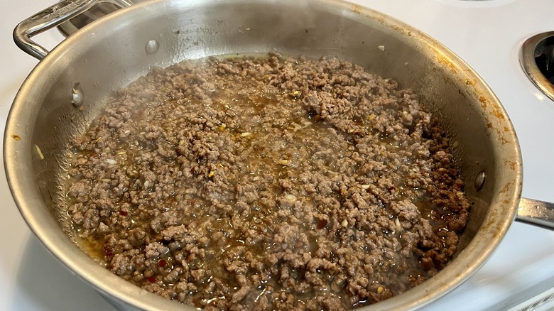 ground beef cooking with sauce