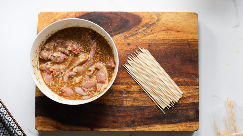 Raw chicken with bamboo skewers