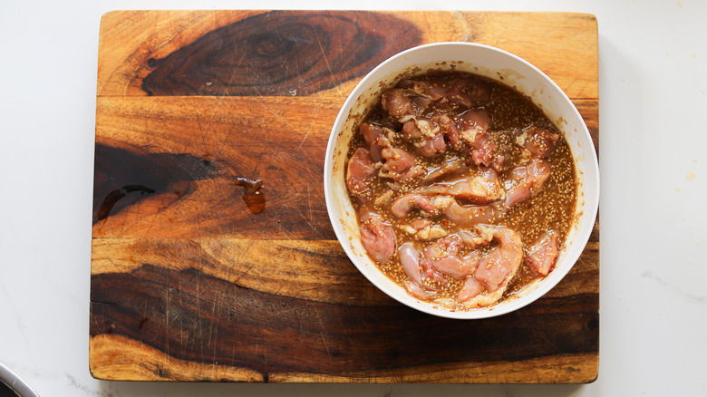 Chicken marinating in bowl