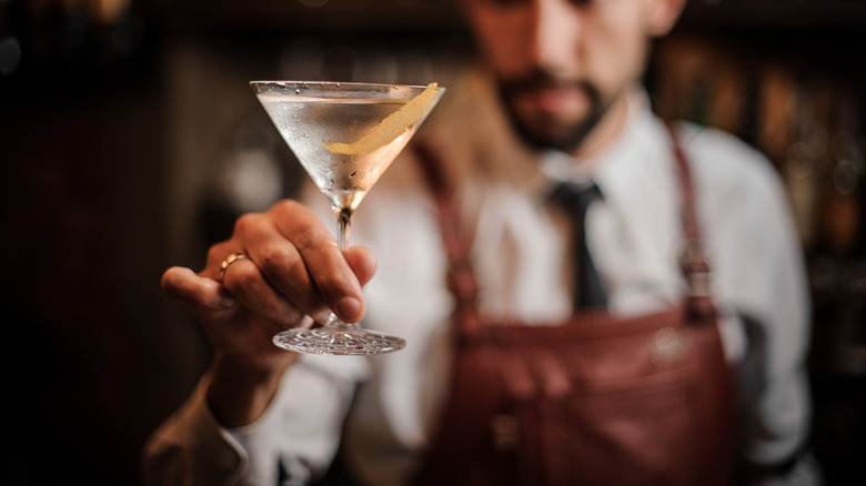 A bartender holding a Martini 