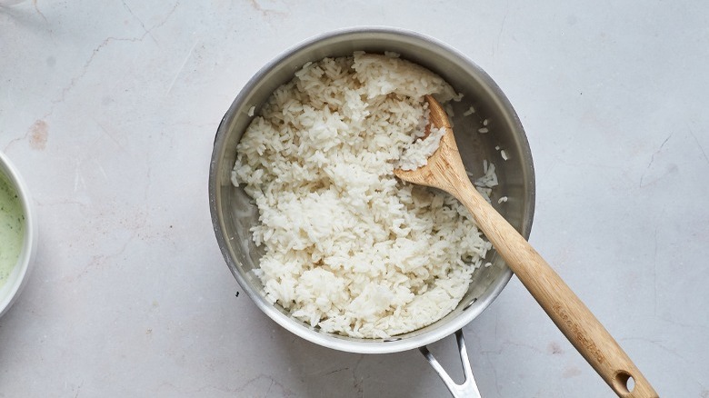 fluffing white rice in saucepan