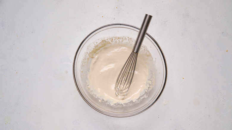 whisking dressing in bowl